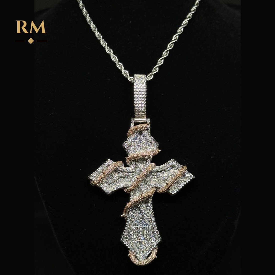 Iced thorn cross pendant in silver with pink stones, on a rope chain